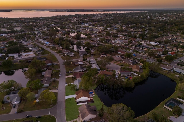 aerial view at dusk with a water view