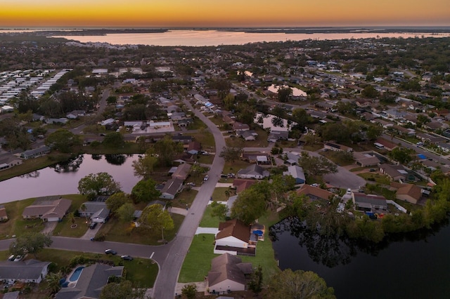 aerial view at dusk with a water view