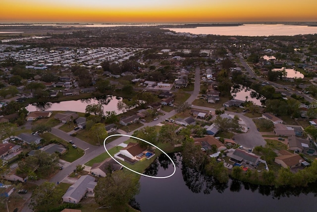 aerial view at dusk with a water view