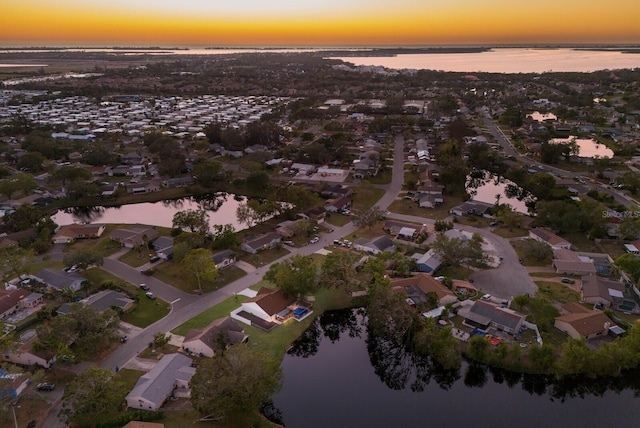 aerial view at dusk with a water view