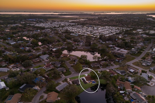 aerial view at dusk with a water view