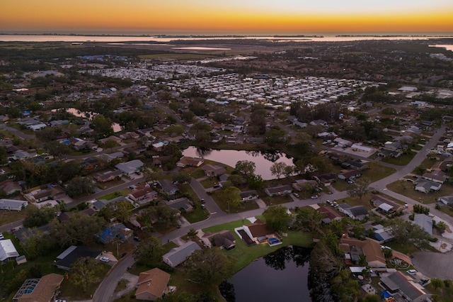 aerial view at dusk with a water view