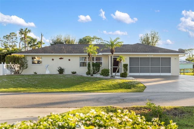 single story home with a garage and a front lawn