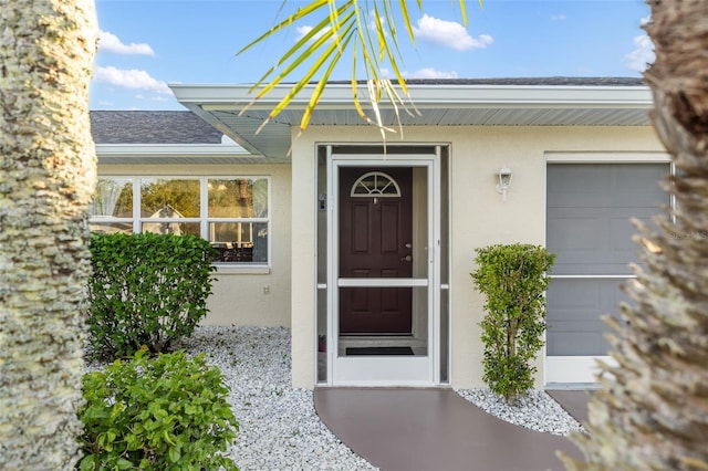 view of exterior entry featuring a garage