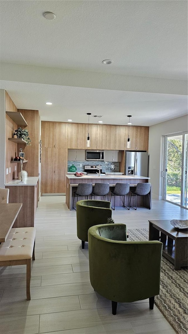 living room with a textured ceiling and light wood-type flooring