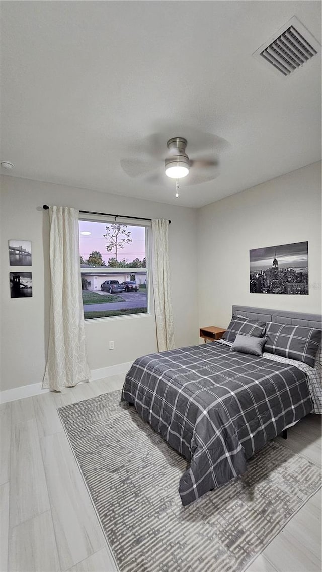 bedroom featuring hardwood / wood-style flooring and ceiling fan