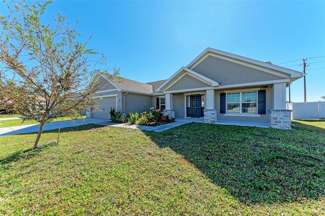 view of front of property featuring a garage, covered porch, and a front yard