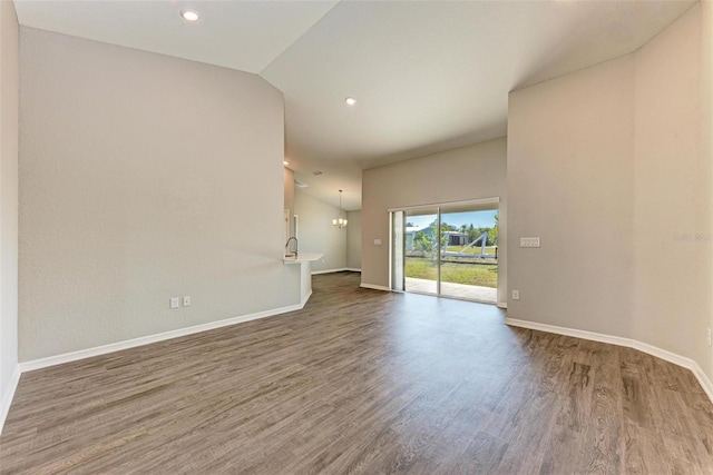 3030 58th Way E, Palmetto, FL 34221 - spare room featuring wood finished floors, baseboards, recessed lighting, a chandelier, and vaulted ceiling