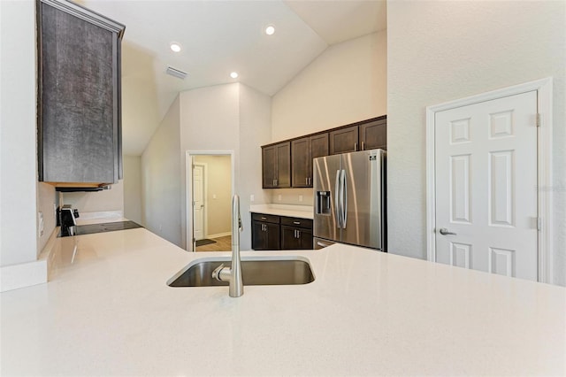3030 58th Way E, Palmetto, FL 34221 - kitchen with stainless steel fridge with ice dispenser, vaulted ceiling, a sink, dark brown cabinets, and stove