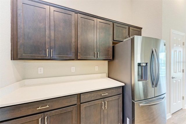 3030 58th Way E, Palmetto, FL 34221 - kitchen featuring stainless steel fridge with ice dispenser, dark brown cabinetry, and light countertops