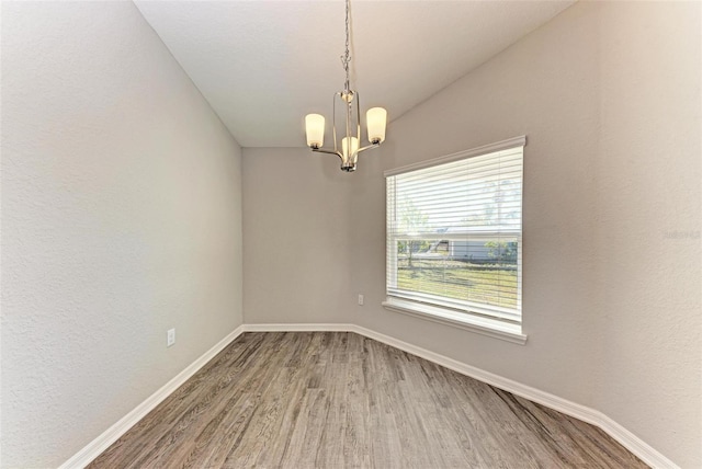 3030 58th Way E, Palmetto, FL 34221 - unfurnished room featuring wood finished floors, a chandelier, and baseboards