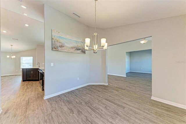 3030 58th Way E, Palmetto, FL 34221 - spare room with a chandelier, light wood finished floors, baseboards, and recessed lighting