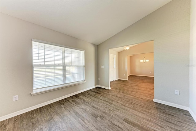 3030 58th Way E, Palmetto, FL 34221 - spare room with vaulted ceiling, a chandelier, wood finished floors, and baseboards