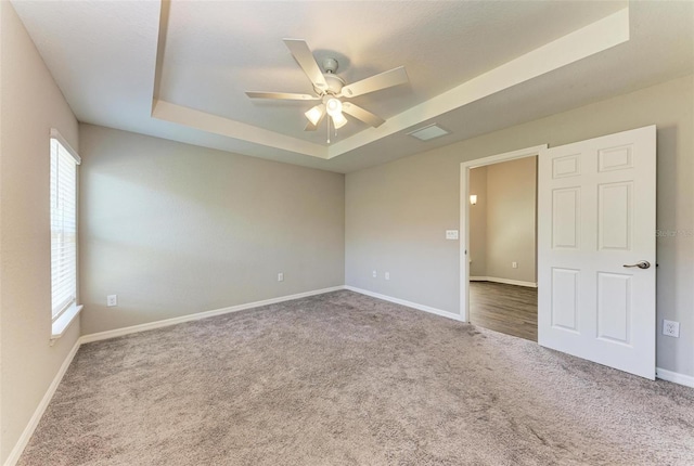 3030 58th Way E, Palmetto, FL 34221 - carpeted empty room featuring a raised ceiling, a ceiling fan, and baseboards