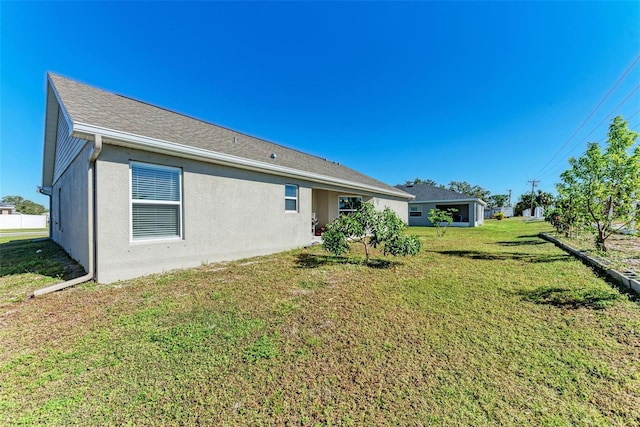 3030 58th Way E, Palmetto, FL 34221 - rear view of property with a lawn and stucco siding