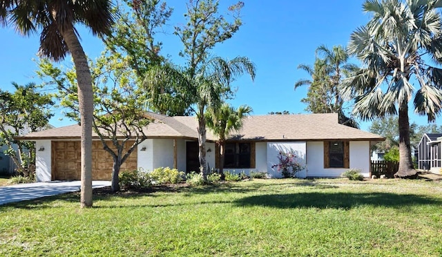 ranch-style house with a garage and a front yard