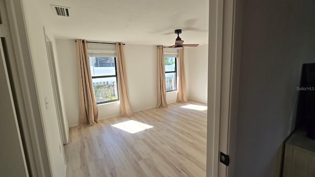 spare room with light hardwood / wood-style floors and ceiling fan