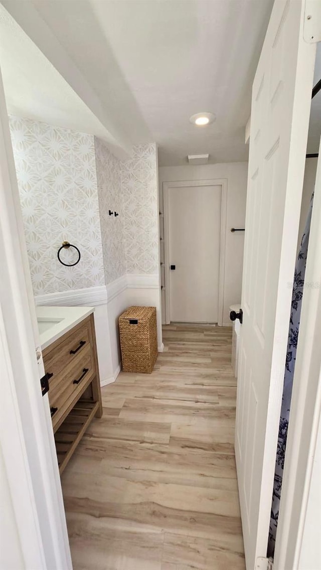 bathroom with vanity and wood-type flooring