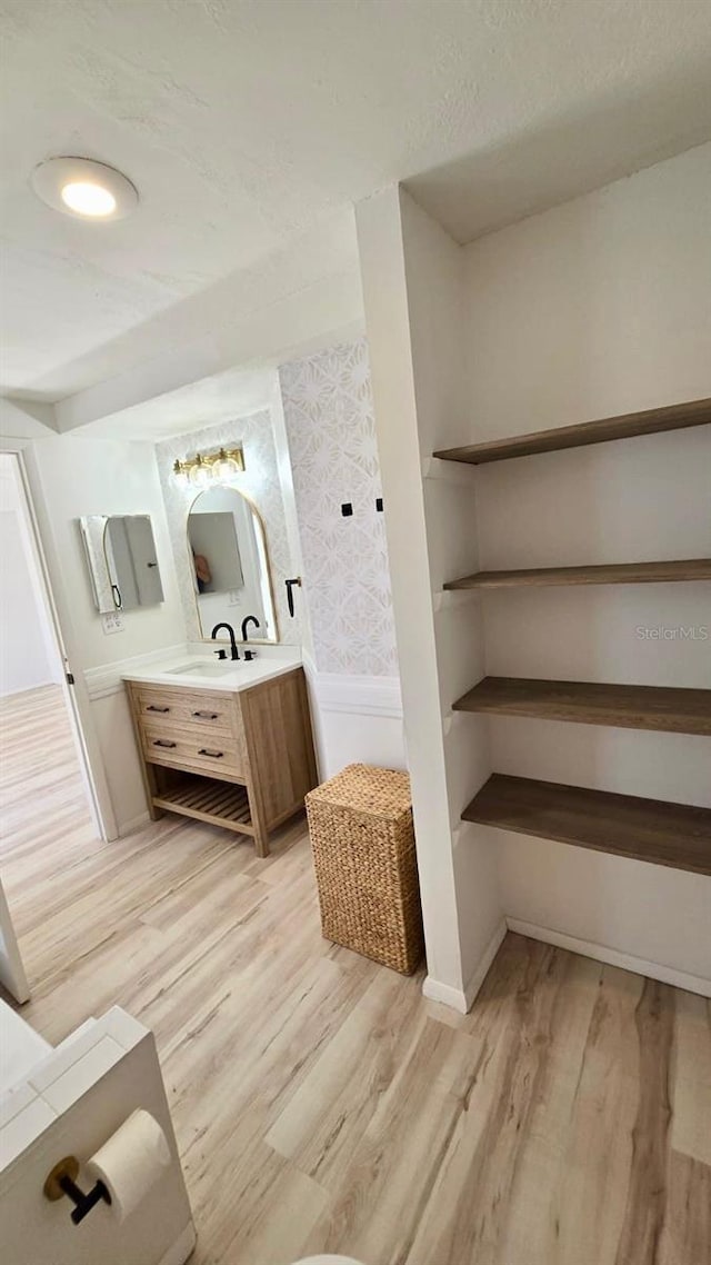 bathroom with vanity and hardwood / wood-style flooring