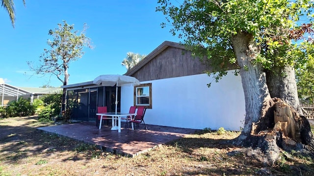 back of property featuring a patio area and a sunroom