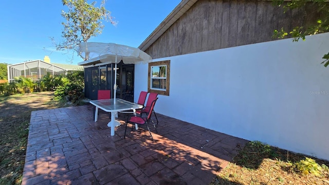 view of patio featuring a sunroom