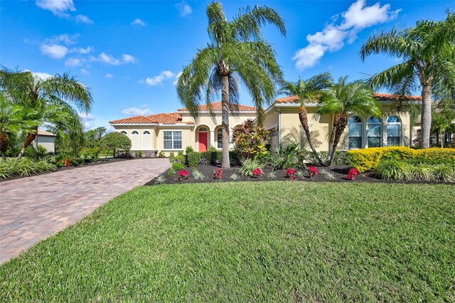 mediterranean / spanish-style house with a front lawn