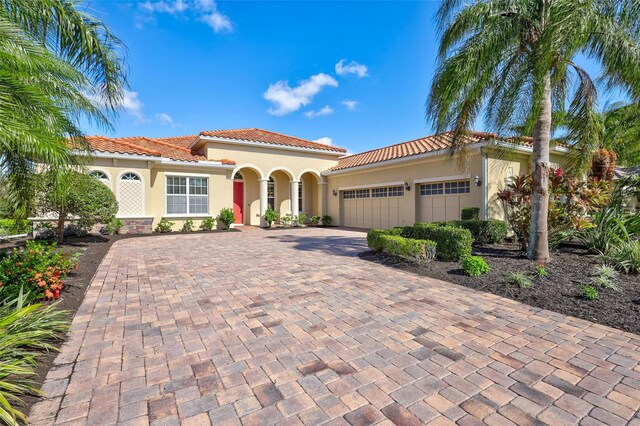 17113 1st Dr E, Bradenton, FL 34212 - mediterranean / spanish-style house featuring a garage