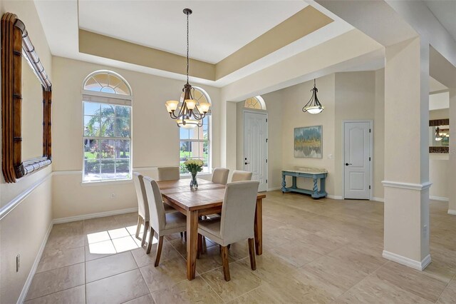 17113 1st Dr E, Bradenton, FL 34212 - dining room featuring a tray ceiling and an inviting chandelier