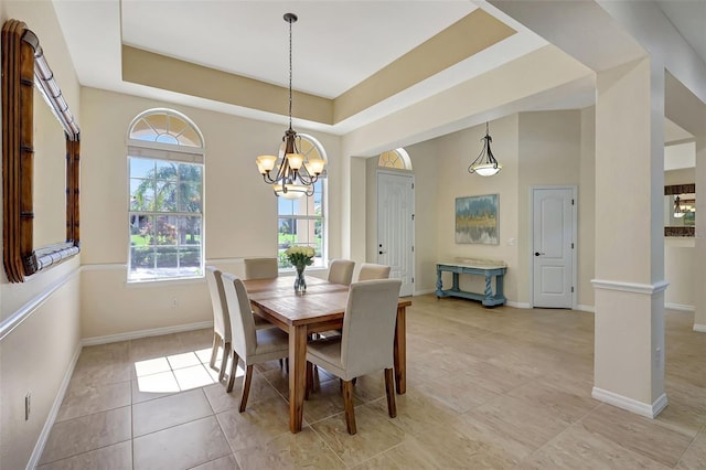 17113 1st Dr E, Bradenton, FL 34212 - dining area with a chandelier, light tile patterned floors, a tray ceiling, and baseboards