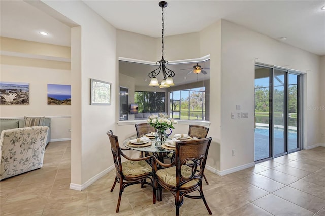 17113 1st Dr E, Bradenton, FL 34212 - dining space with light tile patterned floors and ceiling fan with notable chandelier