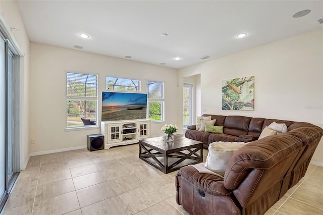 17113 1st Dr E, Bradenton, FL 34212 - living room featuring light tile patterned floors and a healthy amount of sunlight