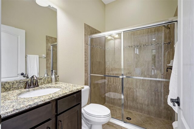 17113 1st Dr E, Bradenton, FL 34212 - bathroom with vanity, toilet, and a shower with shower door