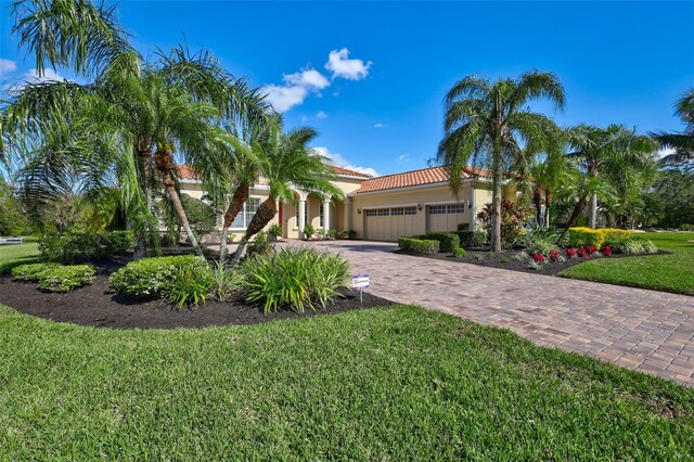 17113 1st Dr E, Bradenton, FL 34212 - mediterranean / spanish house with a garage and a front lawn