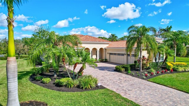 17113 1st Dr E, Bradenton, FL 34212 - mediterranean / spanish-style house featuring a garage and a front yard
