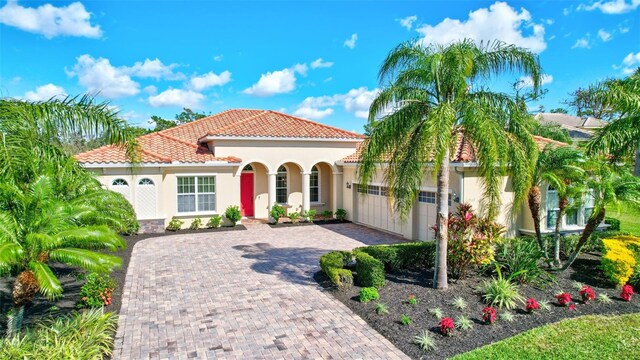 17113 1st Dr E, Bradenton, FL 34212 - mediterranean / spanish-style house featuring a garage