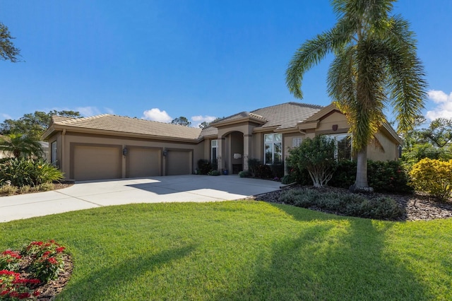 view of front of property featuring a garage and a front lawn