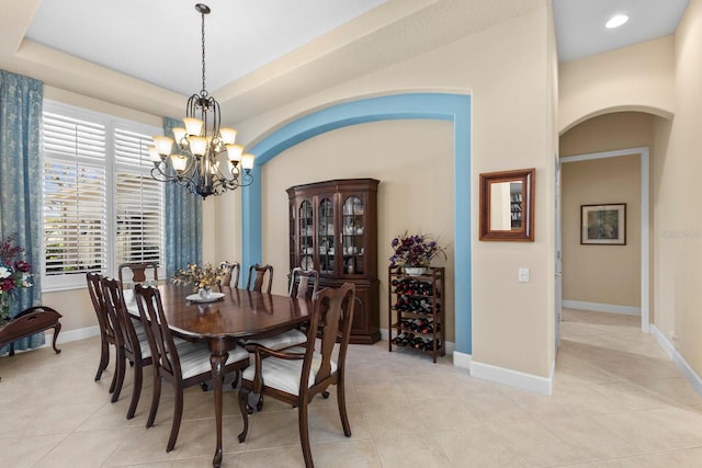 tiled dining area featuring an inviting chandelier