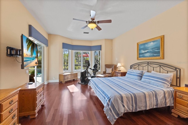 bedroom with dark hardwood / wood-style floors, ceiling fan, and access to outside