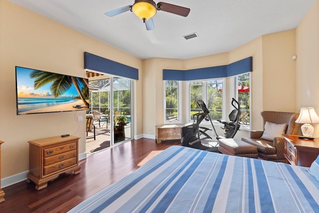 bedroom with access to exterior and dark hardwood / wood-style floors