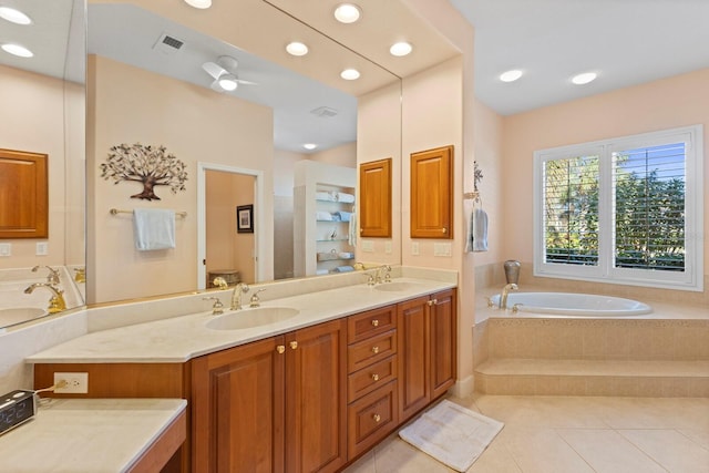 bathroom with vanity, tile patterned floors, ceiling fan, toilet, and tiled bath