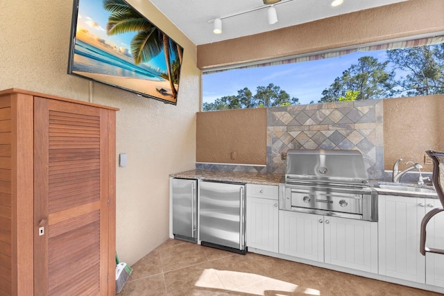 view of patio / terrace featuring a grill, sink, and exterior kitchen