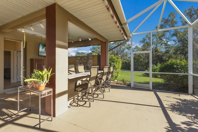 sunroom featuring track lighting