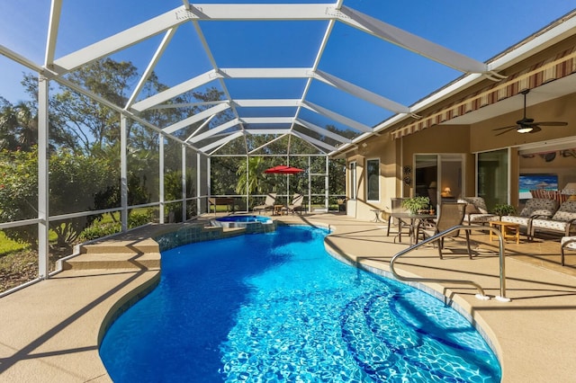 view of pool with ceiling fan, a lanai, an in ground hot tub, and a patio