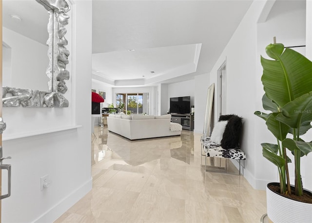 living room featuring a tray ceiling