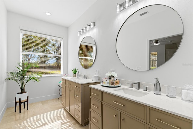 bathroom with tile patterned flooring, vanity, and ceiling fan