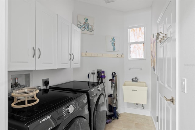 laundry area with cabinets, light tile patterned floors, separate washer and dryer, and sink