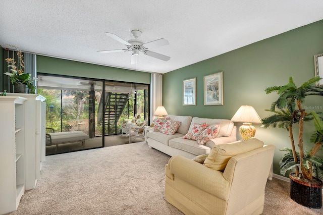 carpeted living room with ceiling fan and a textured ceiling