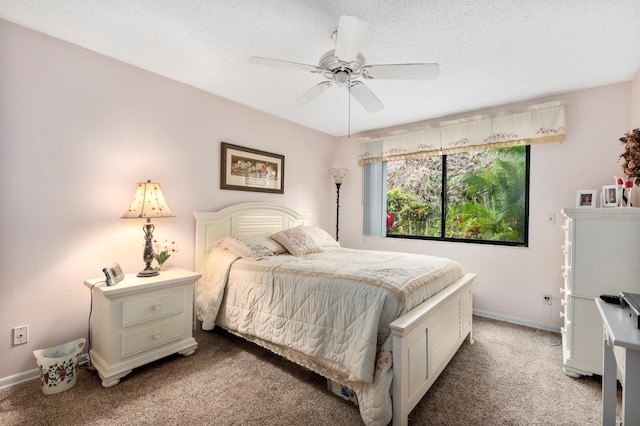 carpeted bedroom with ceiling fan and a textured ceiling