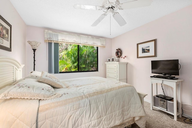 bedroom featuring a textured ceiling, carpet floors, and ceiling fan