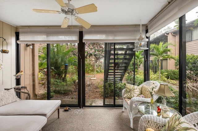 sunroom featuring ceiling fan